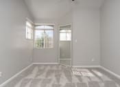 Thumbnail 26 of 48 - A room with a carpeted floor and a ceiling fan.