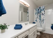 Thumbnail 29 of 48 - A bathroom with a white countertop and a white sink.