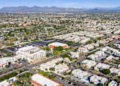 Thumbnail 35 of 48 - A bird's eye view of a residential area with houses and a large building in the center.