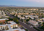 Thumbnail 46 of 48 - A cityscape with buildings and roads under a clear sky.