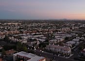 Thumbnail 48 of 48 - A cityscape at dusk with buildings and roads.