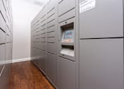 Thumbnail 23 of 80 - a row of gray lockers in a room with hardwood floors and a white wall
