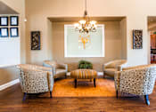 Thumbnail 21 of 80 - a lounge area with four chairs and a coffee table