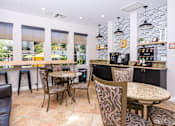 Thumbnail 20 of 80 - a seating area with tables and chairs in front of a counter with a coffee machine and a