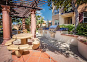 Thumbnail 10 of 80 - a patio with a barbecue grill and a table and chairs