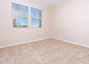Thumbnail 30 of 80 - a bedroom with two windows and beige carpet
