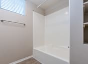Thumbnail 52 of 80 - a bathroom with a white tub and a window