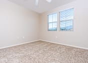 Thumbnail 41 of 80 - a bedroom with beige carpet and two windows