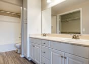 Thumbnail 47 of 80 - a bathroom with white cabinets and a white toilet