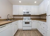 Thumbnail 48 of 80 - a kitchen with white cabinets and white appliances