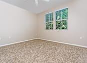 Thumbnail 34 of 80 - a bedroom with beige carpet and two windows