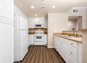 Thumbnail 46 of 80 - a kitchen with white cabinets and white appliances