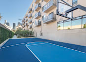 Thumbnail 10 of 26 - A basketball court is located on the balcony of an apartment building at Wilshire Valencia Apartment, Los Angeles, CA
