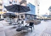Thumbnail 13 of 18 - a patio with tables and umbrellas in front of a building