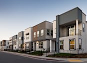 Thumbnail 15 of 48 - A row of modern townhouses with balconies and black railings.