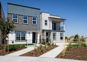 Thumbnail 7 of 50 - a house with a gray and white exterior and a green lawn