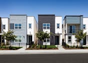 Thumbnail 2 of 50 - a row of townhomes with a street in front of them