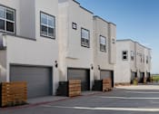 Thumbnail 8 of 50 - a row of apartment buildings with garages