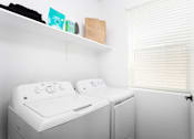 Thumbnail 16 of 50 - a small laundry room with a washer and dryer