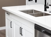 Thumbnail 29 of 50 - a kitchen with white cabinets and a stainless steel dishwasher