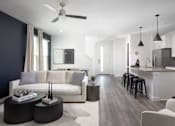 Thumbnail 34 of 149 - A modern living room with a white sofa and a black coffee table.