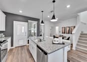Thumbnail 111 of 149 - A modern kitchen with a granite countertop and stainless steel appliances.