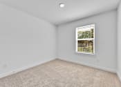 Thumbnail 102 of 149 - A room with a window and carpeted floor.