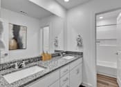Thumbnail 117 of 149 - A bathroom with two sinks and a large mirror.