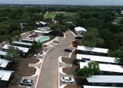 Thumbnail 17 of 97 - New Apartments in South Austin, TX - Casata Austin - Aerial View of Property Showing Apartment Homes, Driveway, Parking Spaces, Swimming Pool, and Green Spaces.