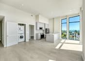 Thumbnail 15 of 117 - A modern kitchen with a washer and dryer built in at Skyview Sunset Apartments, Los Angeles 90046