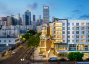 Thumbnail 1 of 89 - a cityscape with a large white building in the foreground and the san francisco skyline in