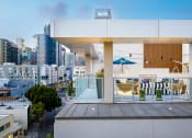 Thumbnail 8 of 89 - South Park, Los Angeles CA Apartments For Rent - Emerald - An Open Air Rooftop Lounge Area With Stylish Seating Overlooking A City Skyline