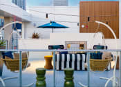 Thumbnail 10 of 89 - a view of a patio area with a couch and chairs and a fire place in the background