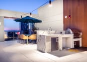 Thumbnail 17 of 89 - Apartments Near FIDM - The Emerald - Rooftop Sky Terrace with Grilling Station Nearby Seating Area, BBQ Grill, and Quarts Outdoor Kitchen Counterspace