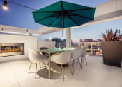 Thumbnail 18 of 89 - a terrace with a table and chairs and a fireplace