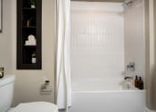 Thumbnail 24 of 89 - a bathroom with a white tub and a white toilet