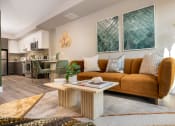 Thumbnail 26 of 89 - Apartments for Rent in Downtown Los Angeles, CA - The Emerald - Living Room with Floor-to-Ceiling Window, Abstract Coffee Table, and Luxury Plank Flooring