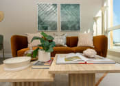 Thumbnail 27 of 89 - Apartments for Rent in Downtown Los Angeles, CA - The Emerald - Living Room with Floor-to-Ceiling Window, Abstract Coffee Table, and Luxury Plank Flooring