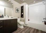 Thumbnail 33 of 89 - a bathroom with a toilet sink and bathtub in a 555 waverly unit