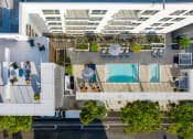 Thumbnail 42 of 89 - an overhead view of a building with a pool and trees