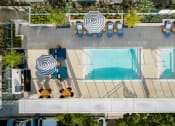 Thumbnail 43 of 89 - an aerial view of a pool and patio with umbrellas