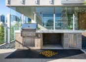 Thumbnail 45 of 89 - an outdoor kitchen with a propane grill and a rug with the emerald logo on it