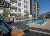 Thumbnail 46 of 89 - an outdoor pool with lounge chairs and umbrellas at the bradley braddock road