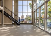 Thumbnail 51 of 89 - a large open space with large windows and a staircase