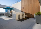 Thumbnail 60 of 89 - an outdoor kitchen and dining area on the roof of a building