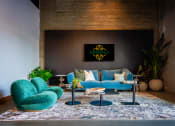 Thumbnail 63 of 89 - a living room with a blue couch and two turquoise chairs