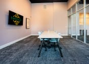 Thumbnail 70 of 89 - a meeting room with a white table and chairs