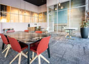 Thumbnail 71 of 89 - a conference room with a glass table and red chairs
