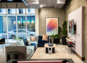 Thumbnail 80 of 89 - a living room with a blue couch and a coffee table in front of a large window