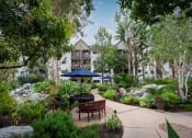 Thumbnail 24 of 36 - Lush courtyard at 55+ FountainGlen Goldenwest, Westminster, CA
